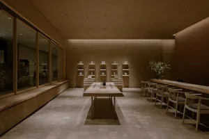 A warm and inviting dining space with a wooden table and chairs, well-lit by natural and artificial light