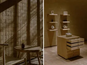 A cozy dining room with wooden floors, white walls, a dining table, chairs, and a countertop with cabinets, featuring natural light and several bottles