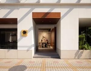 A well-lit dining area with chairs, a table, and artwork on the walls, creating a welcoming atmosphere for patrons