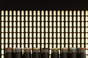A row of five black boxes with white Polo logos on a wall, arranged in a clean and modern style