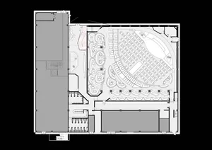 A large auditorium with multiple rows of chairs, a black and white color scheme, and a spacious and inviting atmosphere