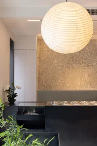 Dining area with a round table, metal or glass table, wine glasses, and elegant atmosphere
