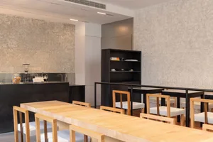 Warm and inviting dining space with multiple wooden tables and chairs, suitable for events or gatherings