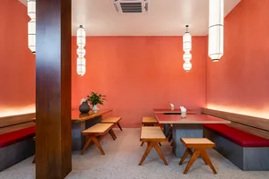 Warm restaurant with wooden tables and chairs, cozy atmosphere, and inviting lighting