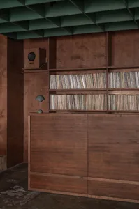 A wooden bookshelf with multiple levels and books, creating a cozy and intellectual environment