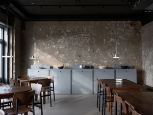 Modern restaurant interior with tables, chairs, and bowls, featuring a focus on functionality and comfort