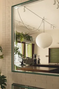 A well-equipped kitchen with a dining table, appliances, and potted plants, creating a comfortable space for cooking and dining