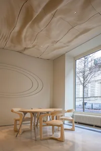Warm and inviting restaurant interior with wooden tables and chairs, creating a cozy seating area for customers
