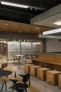 Cozy cafe interior with wooden floors and walls, featuring benches and chairs, and a focus on comfort and functionality
