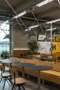An inviting restaurant interior with multiple dining tables and chairs, creating a comfortable atmosphere for socializing and dining