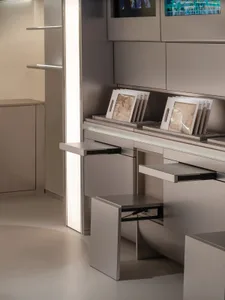 A professional office space with three tables and chairs, surrounded by books and vases, with a sense of organization and calmness