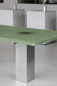 A modern cafe scene with a green metal tabletop and white minimalist walls