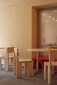 Warm and inviting restaurant interior with wooden tables and chairs, multiple dining tables, and ample seating options