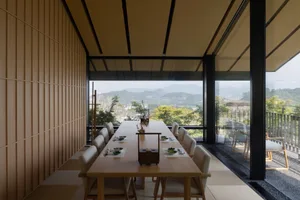 A warm and inviting dining area with a wooden table, chairs, and several bowls, perfect for family gatherings