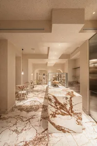 Modern kitchen with a marble island, comfortable seating, and upscale design elements