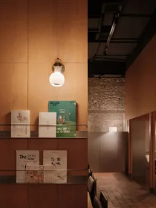Cozy bookstore with wooden shelves, books, and a chair, creating a warm and inviting atmosphere