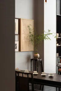 Dining area with wooden tables, chairs, and multiple cups, set in a warm and inviting atmosphere