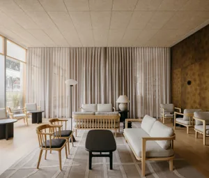 Warm and inviting living space with wooden floors and walls, featuring comfortable seating areas and dining tables