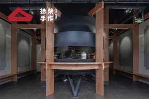 Busy commercial kitchen with a large oven, two people, and kitchen equipment
