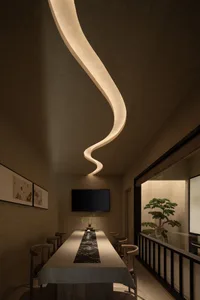 Dining area with a modern table and chairs, a mounted TV, and an elegant atmosphere