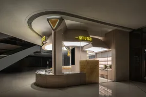 A well-lit commercial space with two cash registers, a large window, and a clean atmosphere