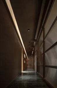 Empty hallway with wooden walls and floors, creating a warm and classic atmosphere