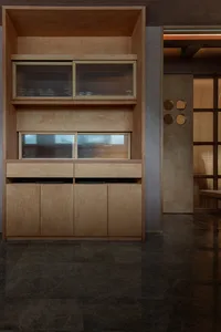 Modern interior design featuring wooden cabinets and drawers with glass doors, providing ample storage solutions in a warm and inviting atmosphere