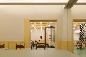 A well-lit restaurant interior with a dining table surrounded by chairs, creating a welcoming space for socializing and enjoying meals together