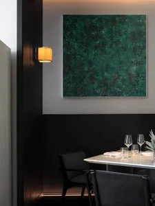 Elegant dining space with a dark wood table and chairs, glassware, and fine china, set in a sophisticated atmosphere