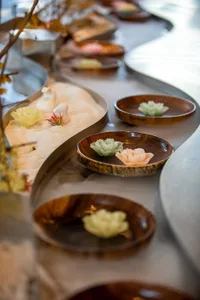 A table display of various bowls containing different types of food, arranged to create an inviting and appetizing atmosphere