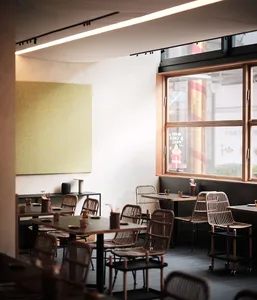 Modern restaurant interior with wooden elements, neutral color palette, and multiple dining tables and chairs