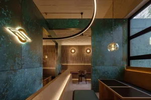 Inviting restaurant interior with wooden accents, multiple dining tables, and a bar, featuring comfortable seating and a warm atmosphere