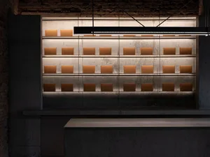 A well-lit store display featuring several rows of brown boxes on a countertop, arranged in a clean and organized manner