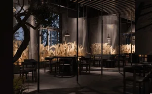 Modern restaurant interior with wooden paneling, tables, chairs, and potted plants, creating a warm and inviting atmosphere