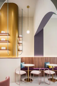 Warm and inviting restaurant interior with wooden floors and walls, featuring dining tables and chairs, and personal belongings left by customers