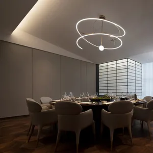A sophisticated dining area with a round table set for dinner, surrounded by chairs and wine glasses