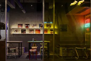 Bright and inviting showroom with glass walls, chairs, dining tables, and books, showcasing different seating styles