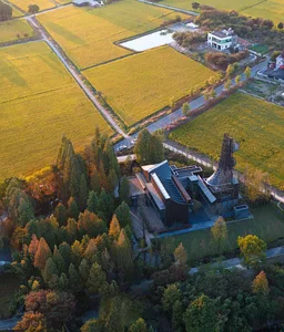A serene house with a tower surrounded by trees in a peaceful rural setting