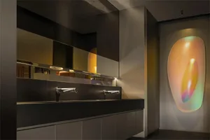 Modern kitchen design featuring two sinks on a black marble countertop with a minimalist and contemporary style