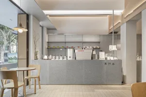Inviting coffee shop interior with a counter, chairs, and various items on display