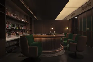 Cozy bar area with a wooden countertop and multiple chairs in a traditional restaurant setting