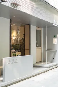 Spacious restaurant interior with modern design, glass doors, and comfortable seating areas