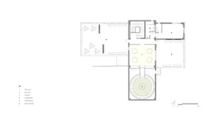 2D floor plan of a modern bathroom with a circular room and dome ceiling, featuring a sink and toilet, with linework and labels