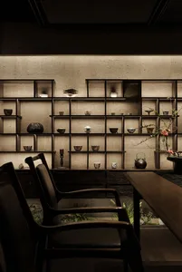 A showroom display of various bowls on shelves, arranged in a neat and visually appealing manner, creating an elegant and sophisticated atmosphere