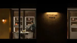 Sophisticated dining space with dark wood accents, wine glasses, and dim lighting