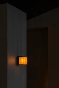 Dimly lit room with a wooden wall and two lights, creating a dark atmosphere