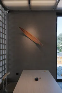 A cozy dining area with a wooden table, chairs, and a bowl, creating a warm and inviting atmosphere
