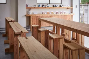 Warm and inviting dining space with wooden tables and benches, creating a cozy and rustic atmosphere