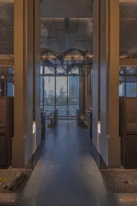 Dimly lit room with two chairs, one near the left side of the doorway and the other near the right side