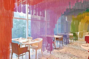 Bright and inviting restaurant interior with wooden tables, chairs, and ample seating options